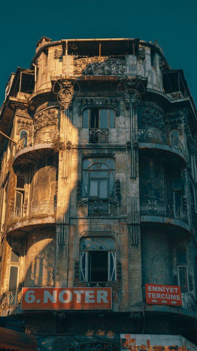 Aged, artistic facade of a historic building with vintage architecture in daylight.